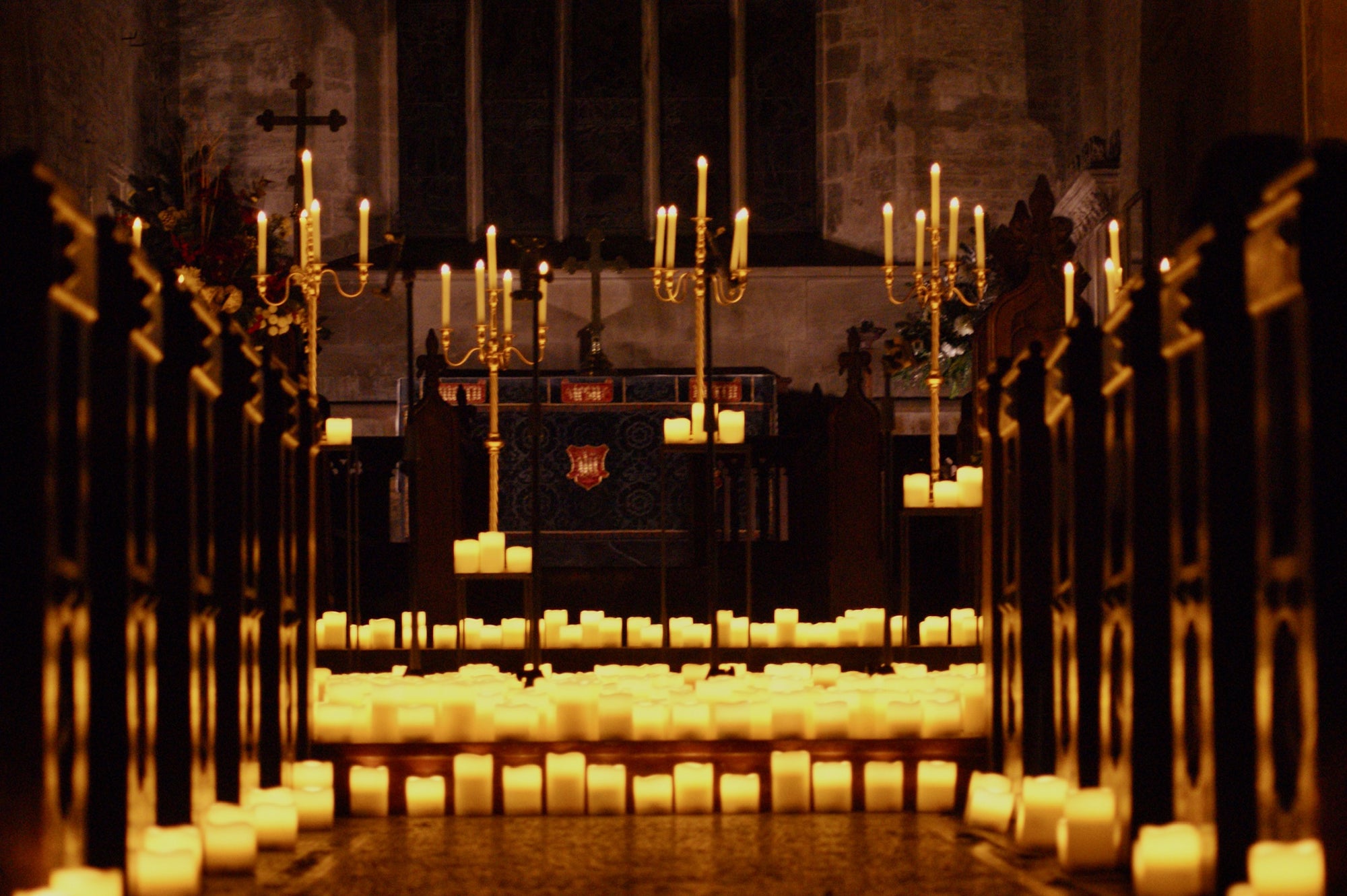 Hundreds of candles in a church, in between pews and on stage.
