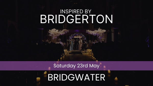 Two musicians playing violin and cello in a decorated indoor setting with candles and floral arrangements. Inspired by Bridgerton Saturday 23rd May Bridgwater